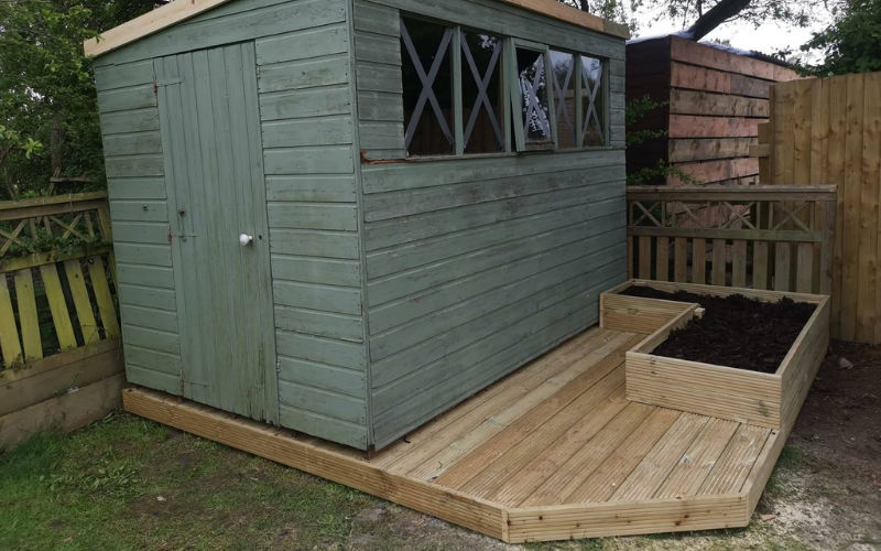 A garden shed on a decking area
