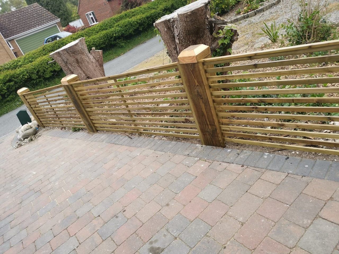 Professional fence installation on a driveway